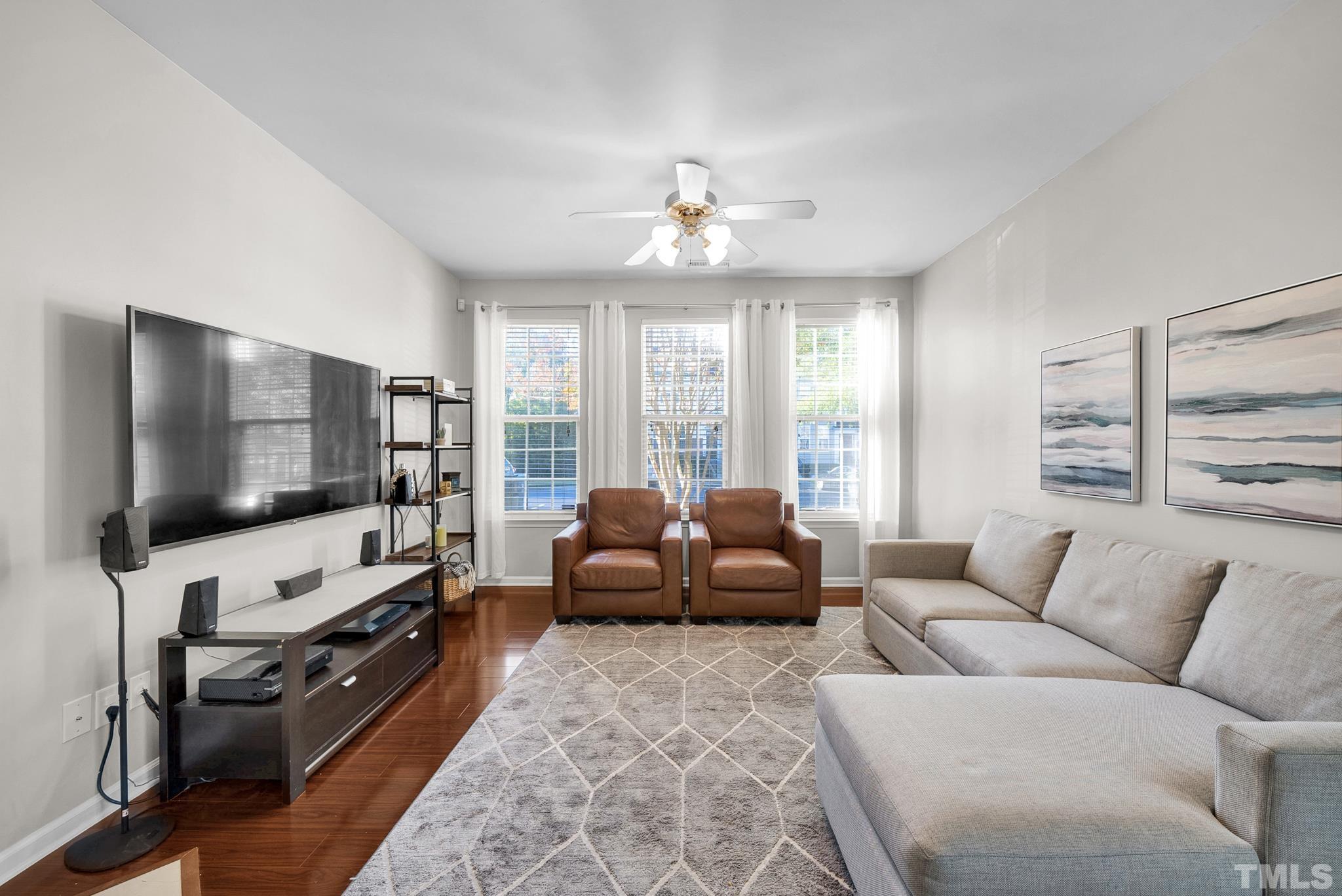 7618 Winners Edge Street Raleigh, NC 27617 - Photo 4 of 22 a living room with furniture and a flat screen tv