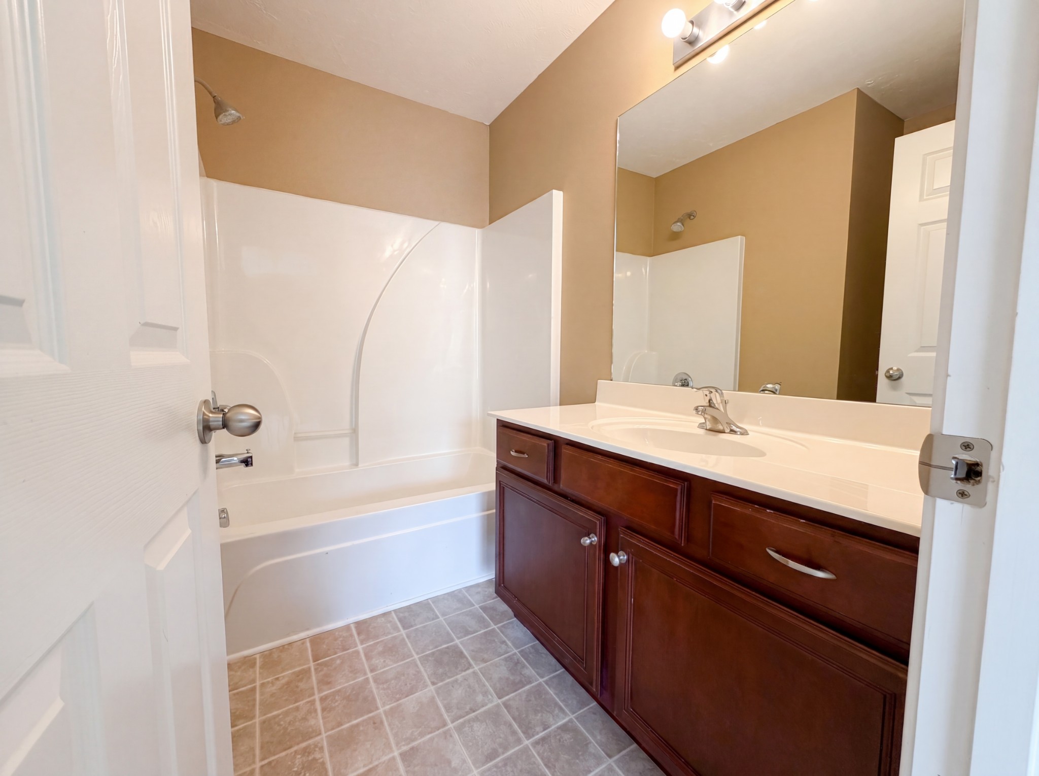 2032 Shaylin Loop Antioch, TN 37013 - Photo 11 of 15 a bathroom with a sink a mirror and a bathtub