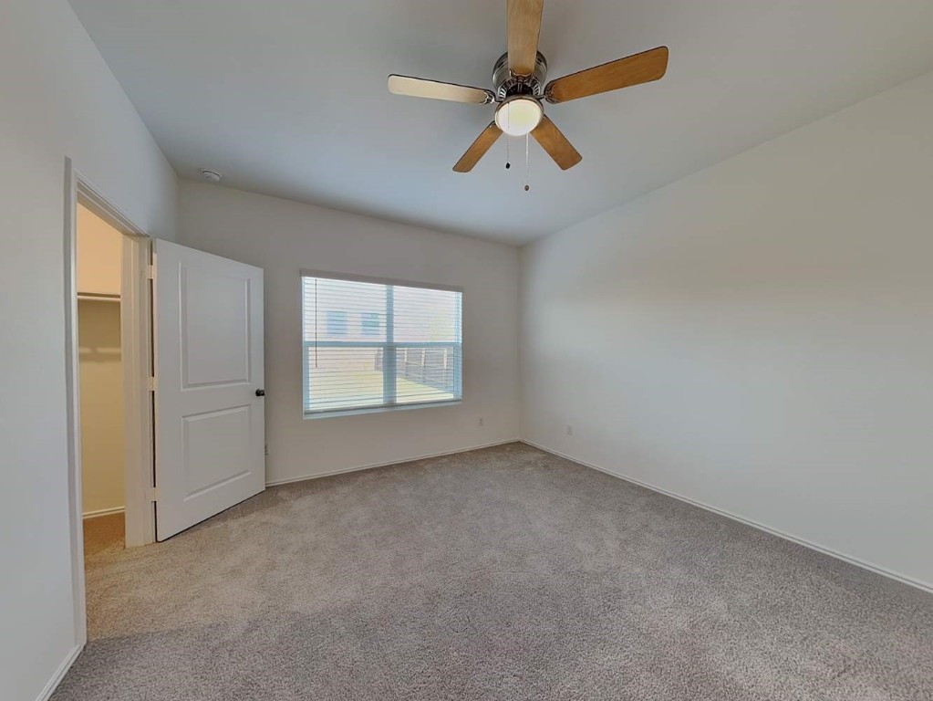 1508 Chapel Ranch Road Georgetown, TX 78628 - Photo 10 of 16 an empty room with a window and a fan