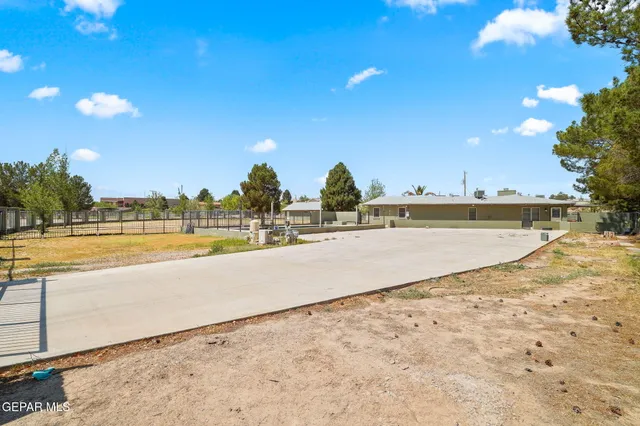 a view of swimming pool with outdoor seating and yard in back
