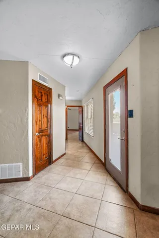 a kitchen with stainless steel appliances granite countertop a refrigerator a stove and a sink with wooden floor