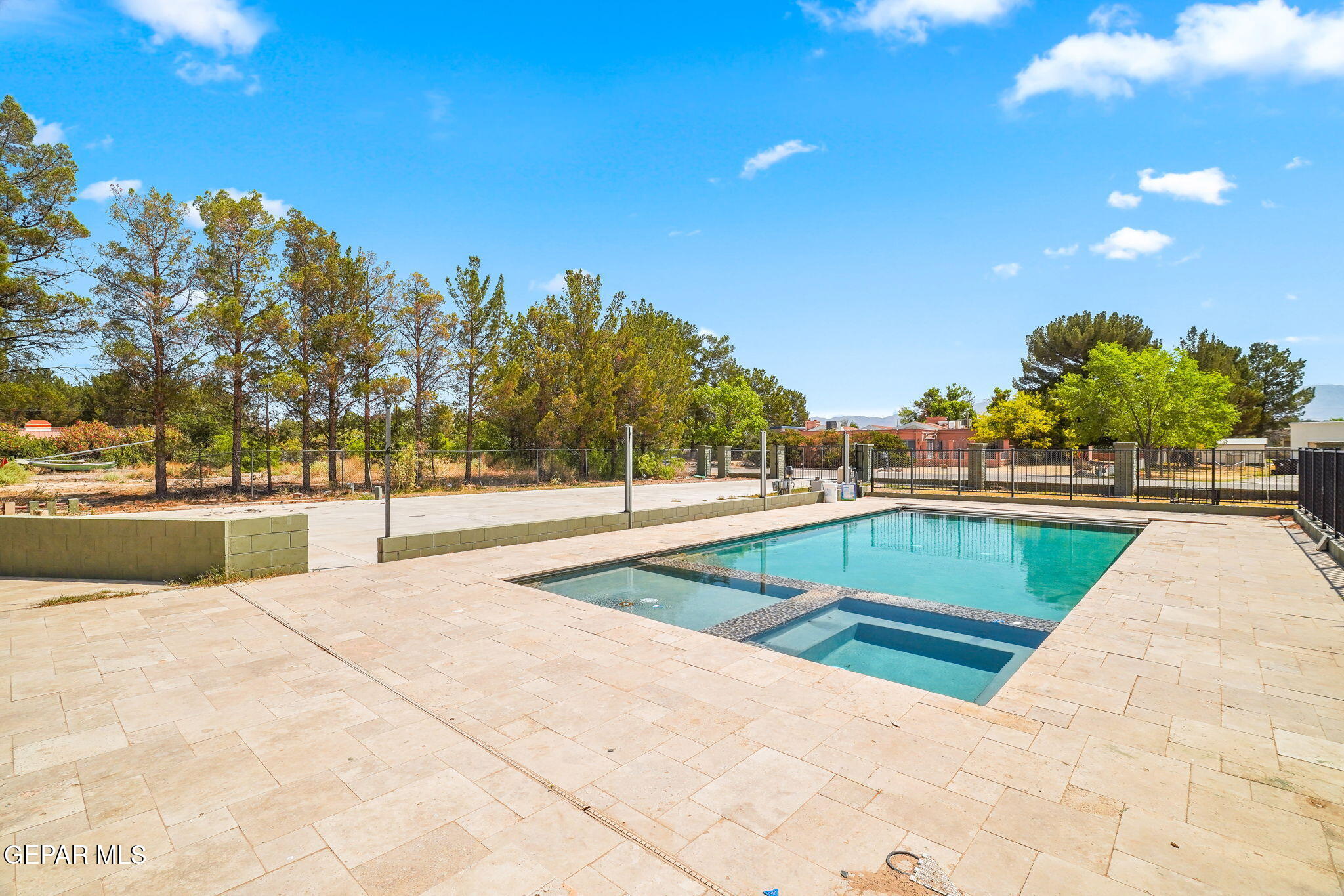 5300 Crawford Road Santa Teresa, NM 88008 - Photo 3 of 87 a view of swimming pool with outdoor seating and trees in the background