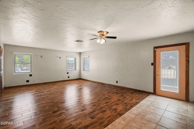 a kitchen with stainless steel appliances granite countertop a sink white cabinets and a refrigerator