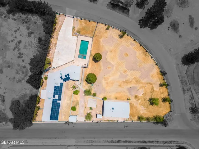 a view of a swimming pool with an outdoor seating and a yard