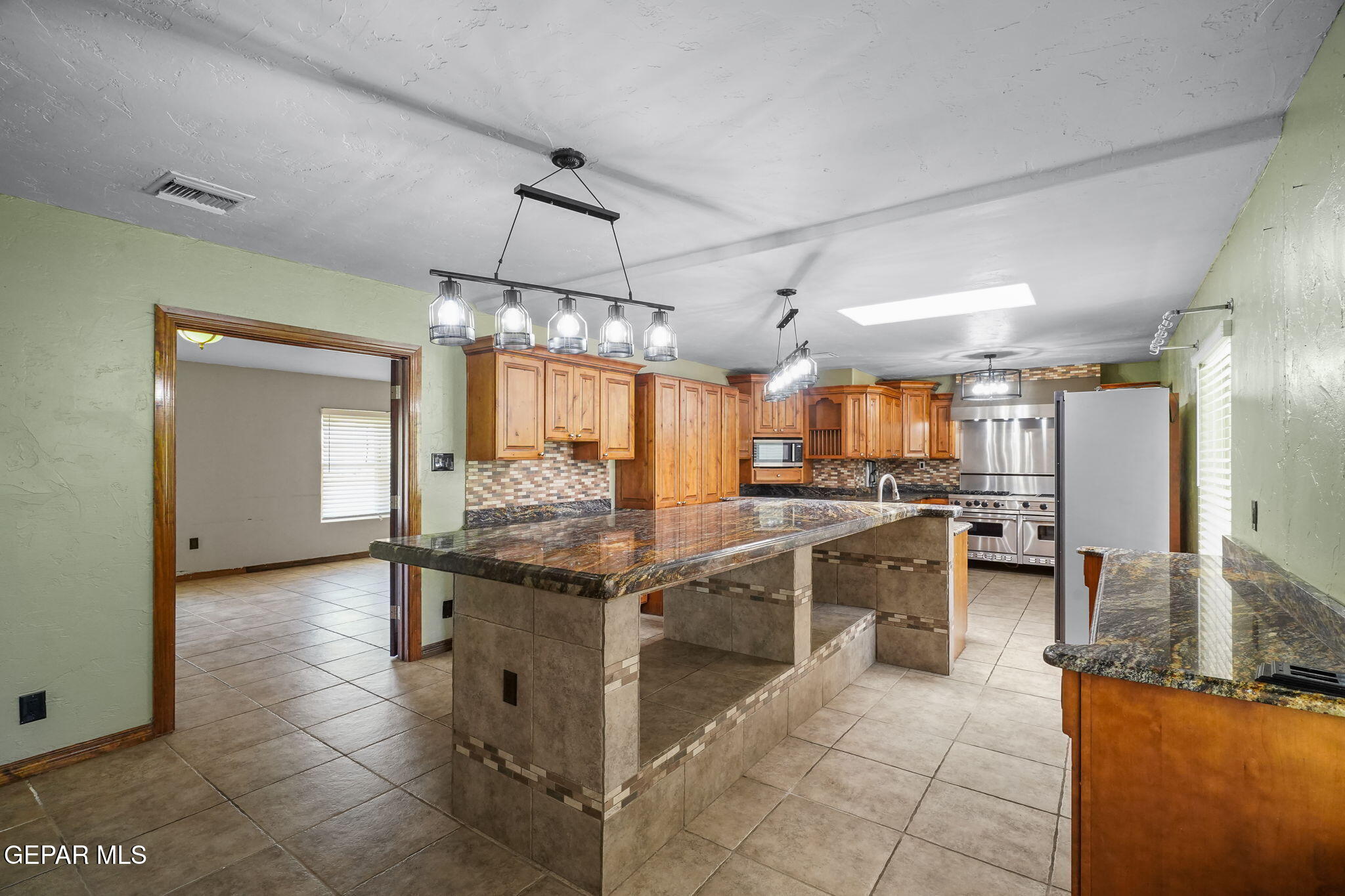 5300 Crawford Road Santa Teresa, NM 88008 - Photo 44 of 87 a kitchen with stainless steel appliances granite countertop counter space a sink and cabinets