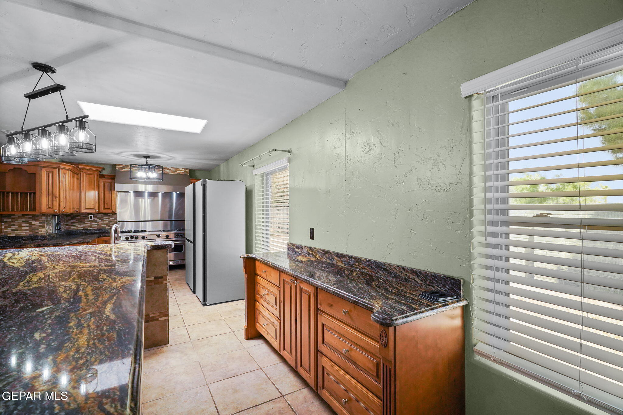 5300 Crawford Road Santa Teresa, NM 88008 - Photo 46 of 87 a kitchen with a stove and a refrigerator