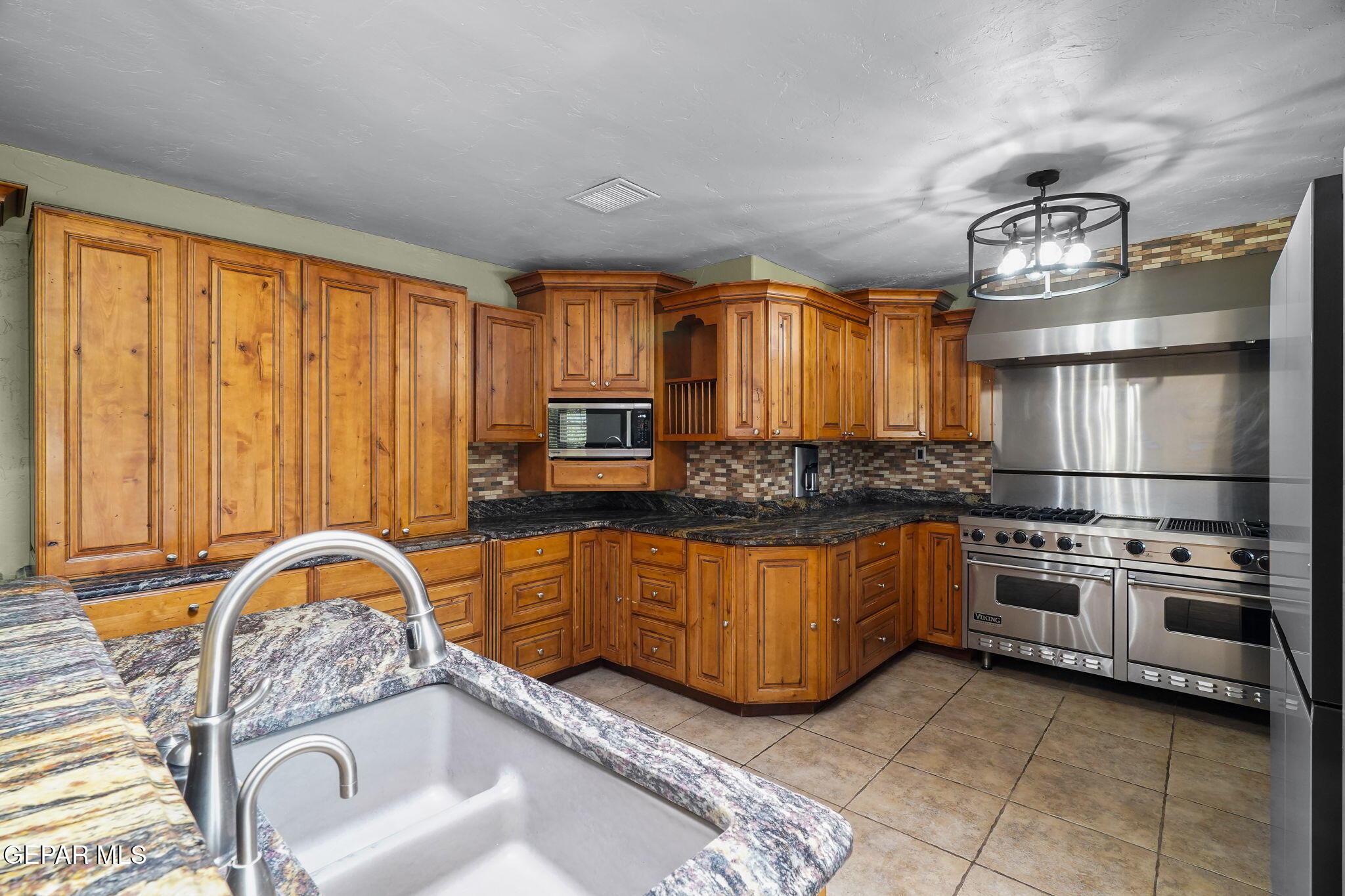 5300 Crawford Road Santa Teresa, NM 88008 - Photo 50 of 87 a kitchen with stainless steel appliances granite countertop a sink white cabinets and a refrigerator