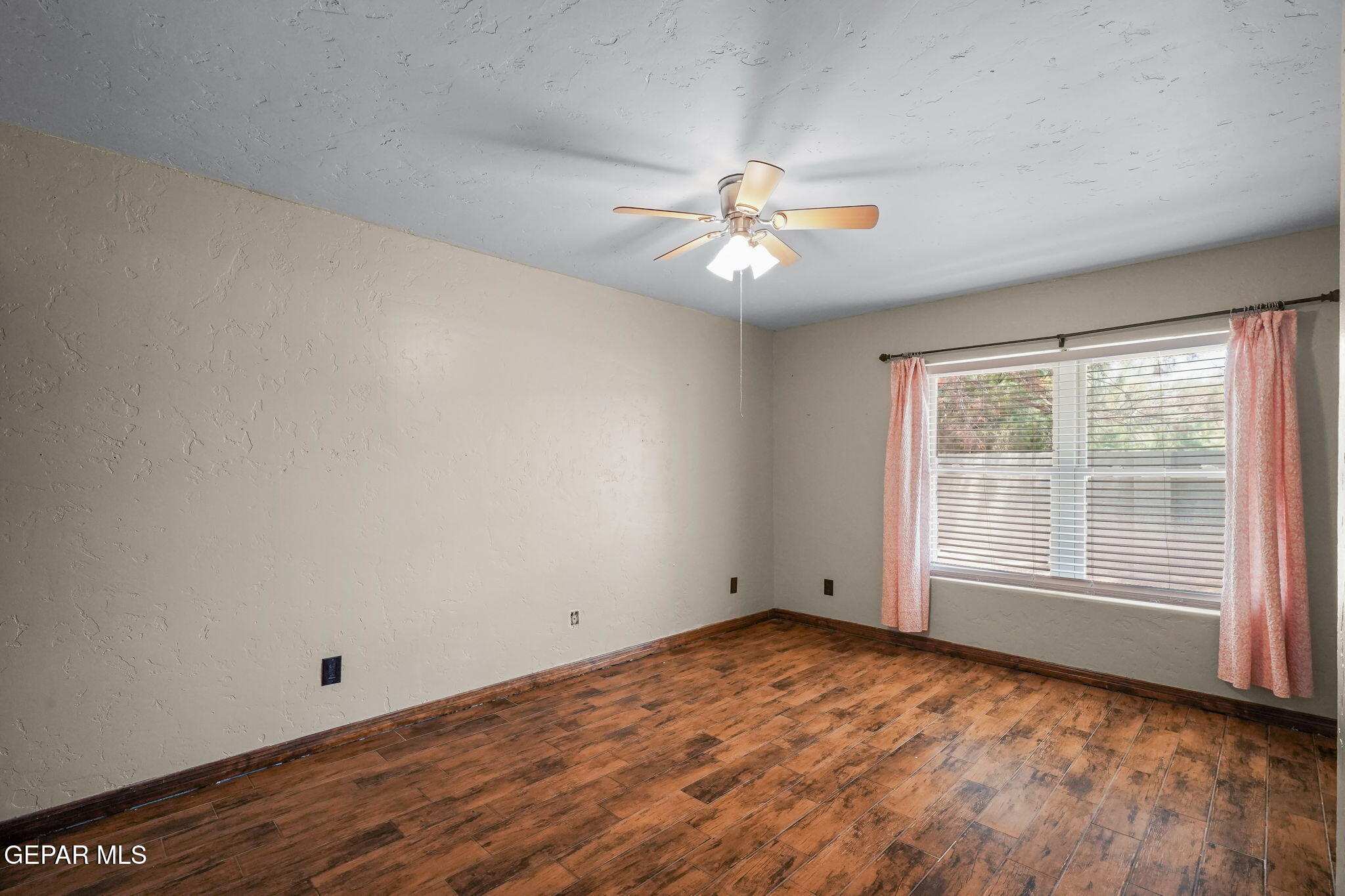 5300 Crawford Road Santa Teresa, NM 88008 - Photo 58 of 87 a view of empty room with wooden floor and fan