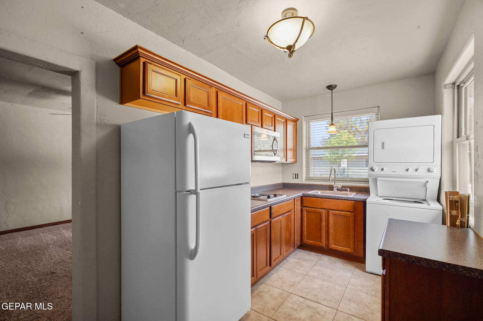 5300 Crawford Road Santa Teresa, NM 88008 - Photo 66 of 87 a kitchen with stainless steel appliances granite countertop a refrigerator and a sink