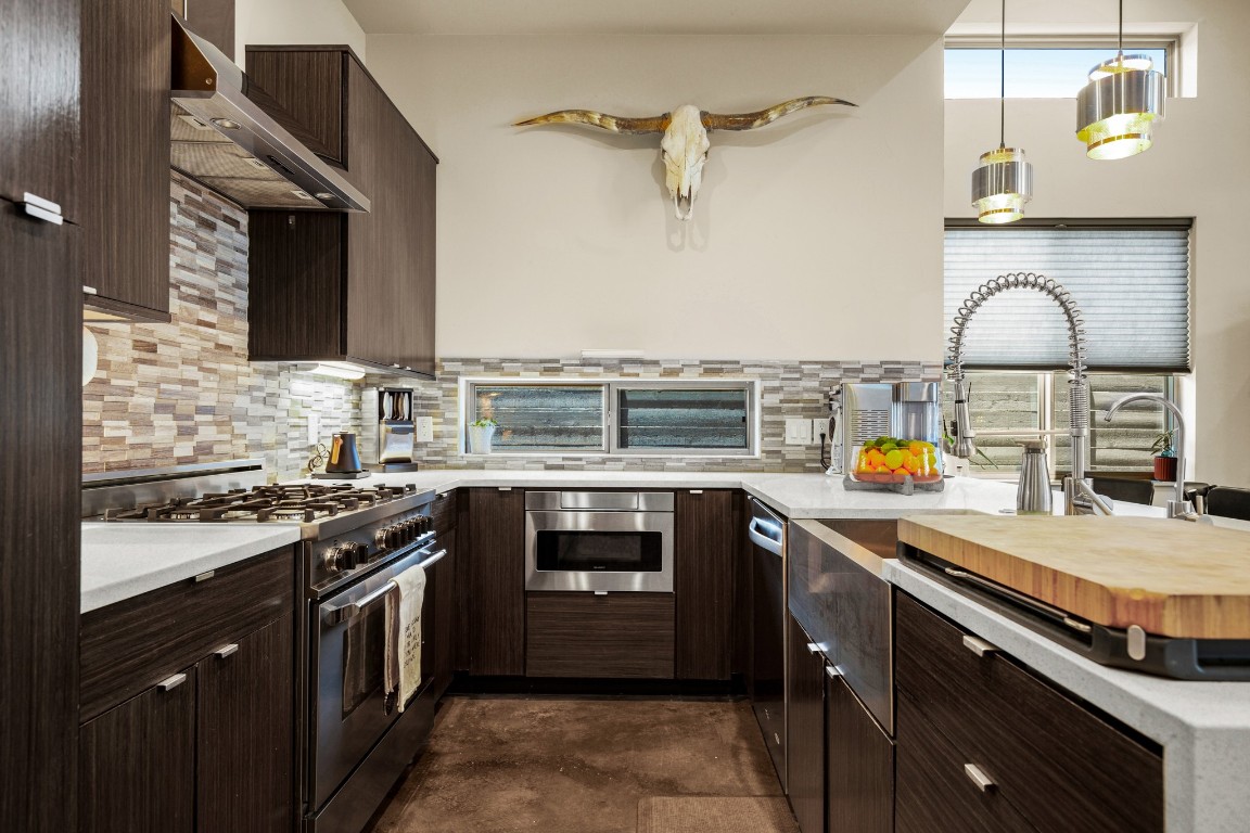 3005 East Martin Luther King Jr Boulevard Austin, TX 78702 - Photo 12 of 39 a kitchen with stainless steel appliances granite countertop a stove and a sink