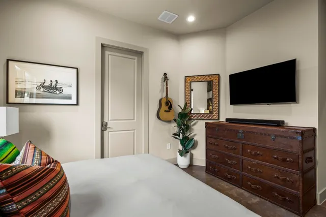 a bedroom with a bed and a painting on the wall