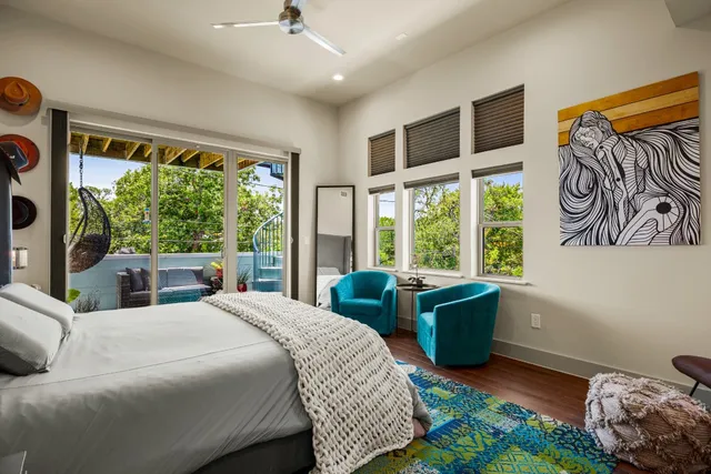 a bedroom with furniture and a flat screen tv