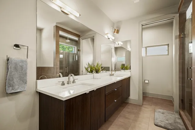 a balcony with wooden floor table and chairs