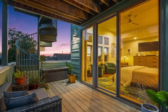 a view of a terrace with couches and wooden fence