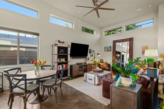 a view of living room with furniture and a book shelf