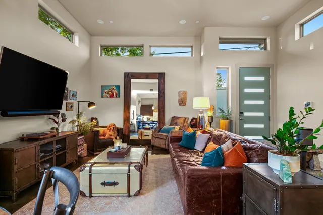 a kitchen with a table chairs refrigerator and cabinets