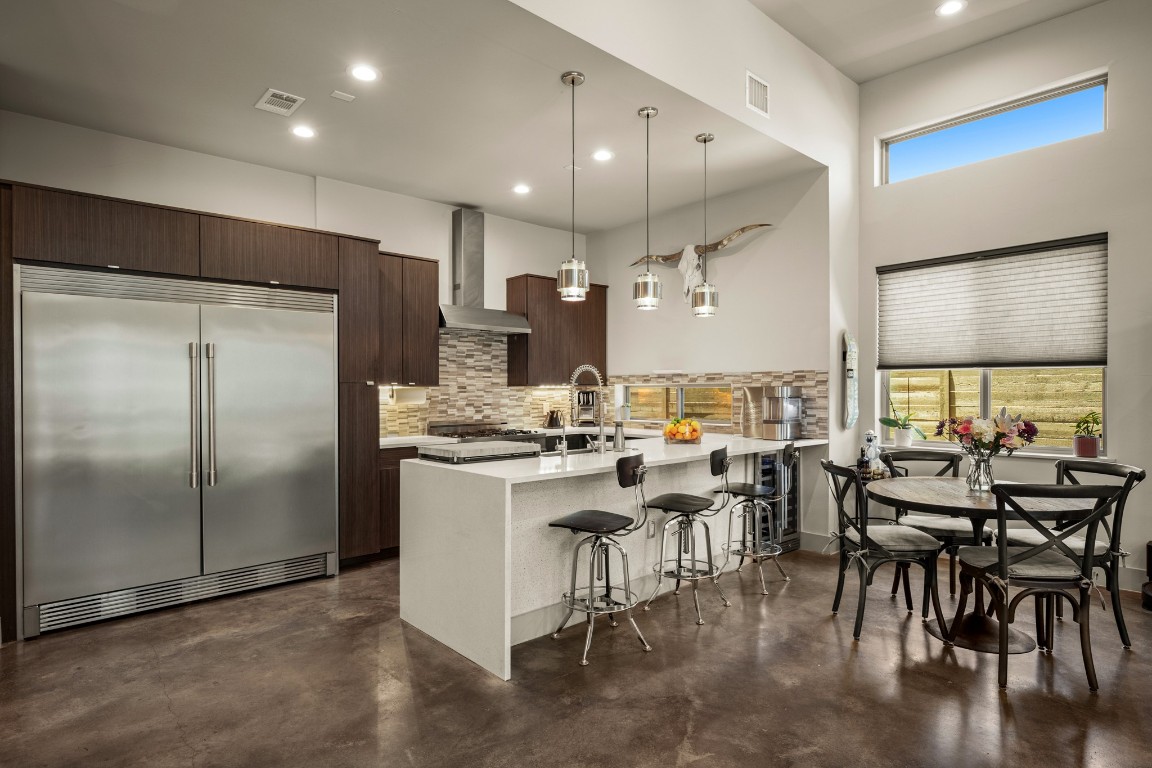 3005 East Martin Luther King Jr Boulevard Austin, TX 78702 - Photo 7 of 39 a kitchen with a table chairs refrigerator and cabinets