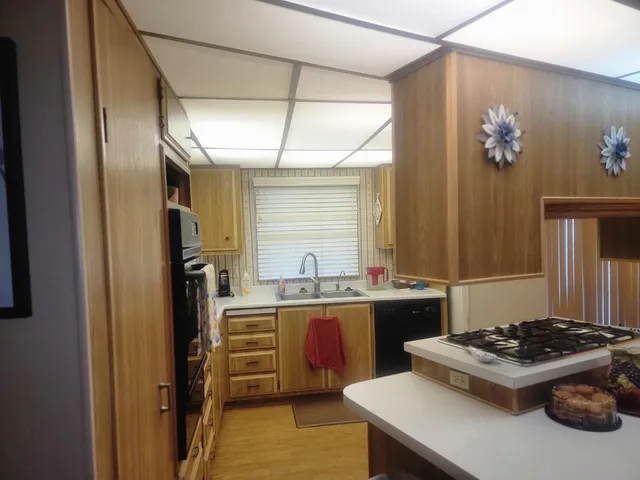 a kitchen with a sink stove and refrigerator