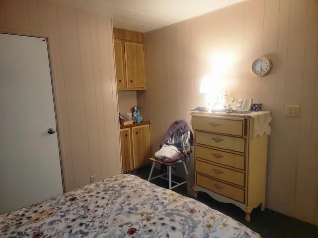 a bedroom with a bed and chair