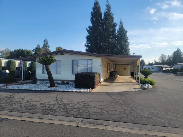 a view of a house with car parked