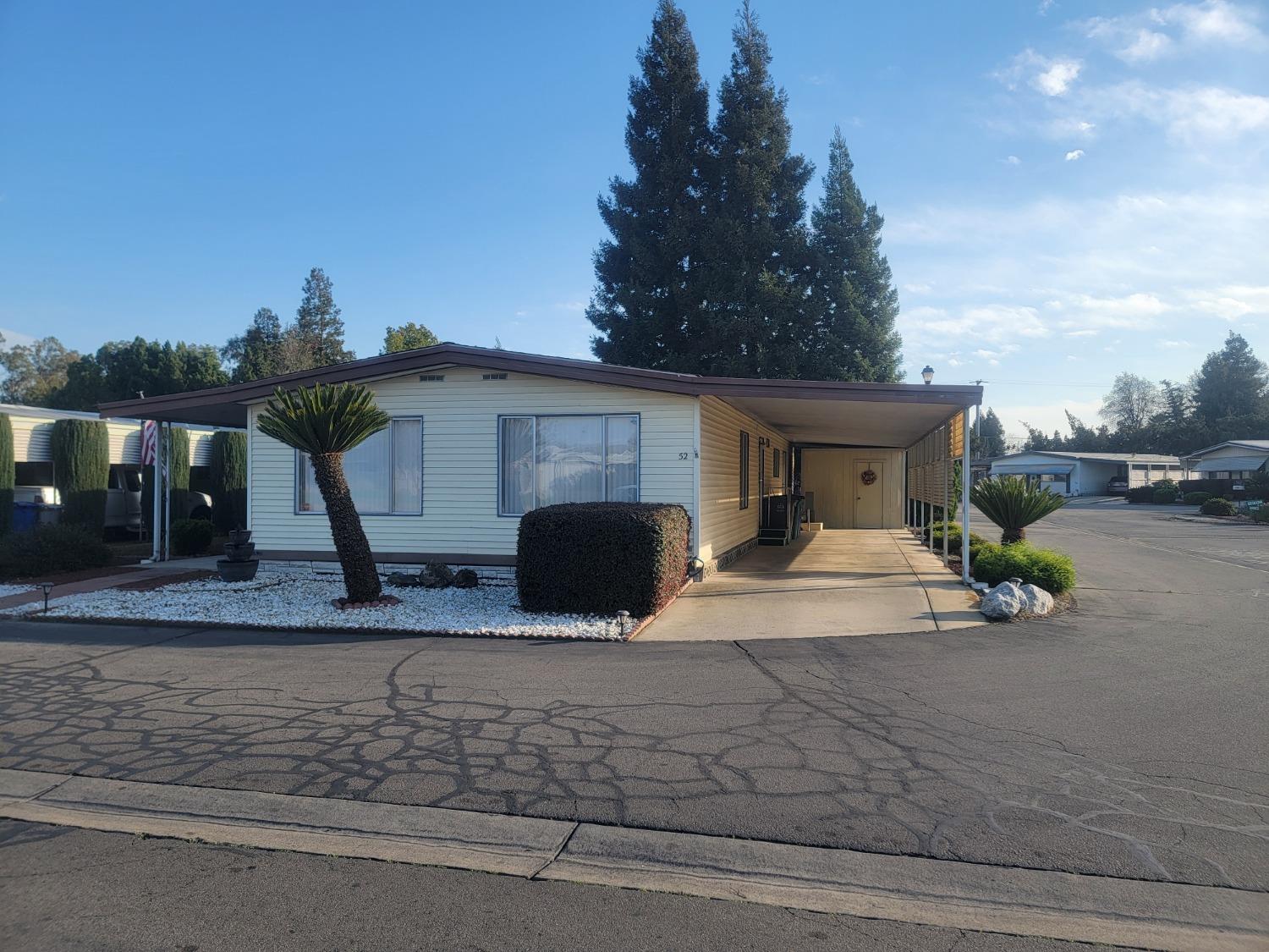 1300 West Olson Avenue, Unit 52 Reedley, CA 93654 - Photo 25 of 26 a view of a house with car parked