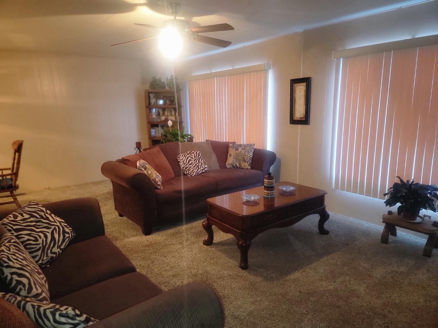 1300 West Olson Avenue, Unit 52 Reedley, CA 93654 - Photo 4 of 26 a living room with furniture and a potted plant