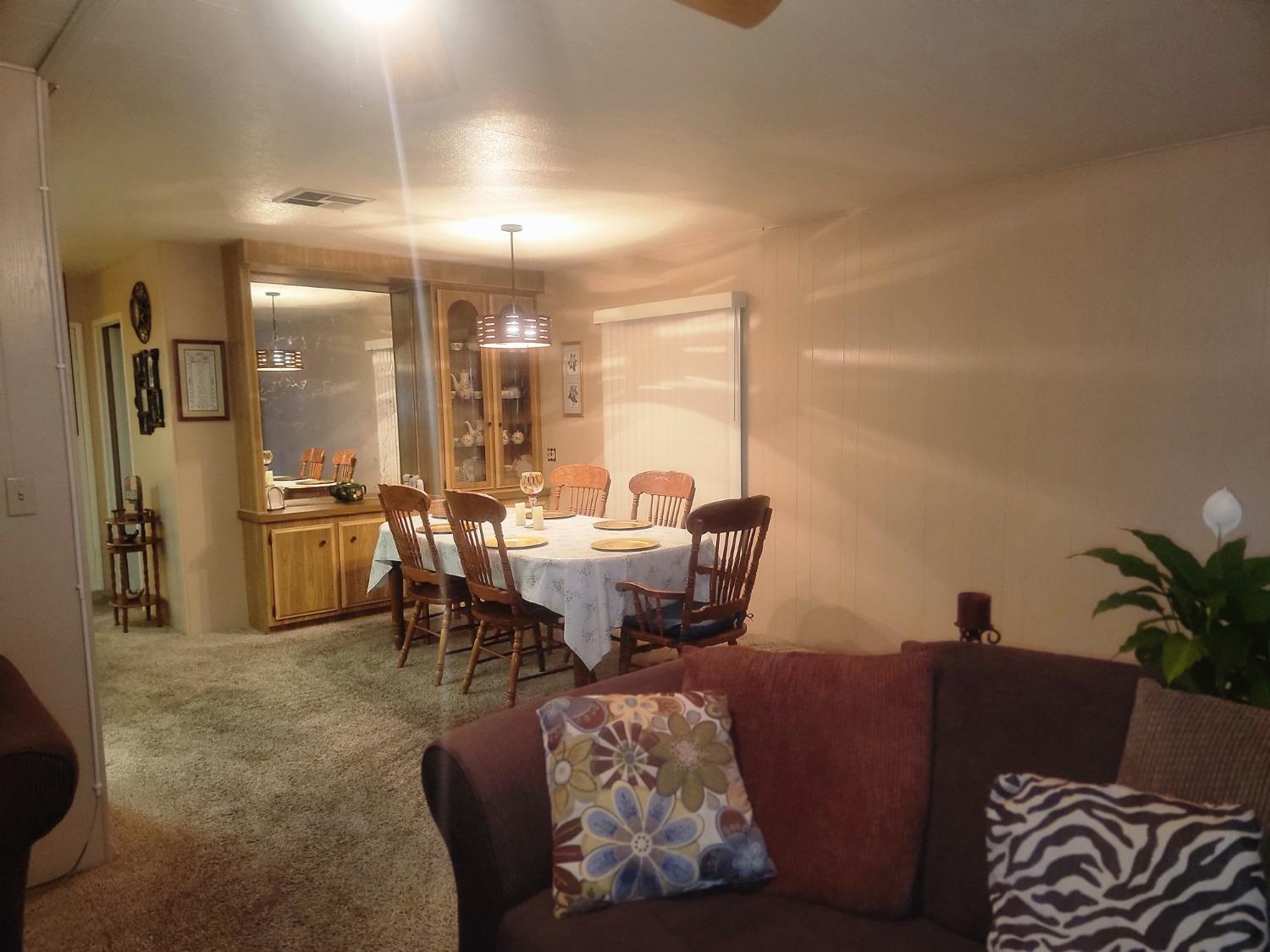 1300 West Olson Avenue, Unit 52 Reedley, CA 93654 - Photo 6 of 26 a living room with furniture and a large window