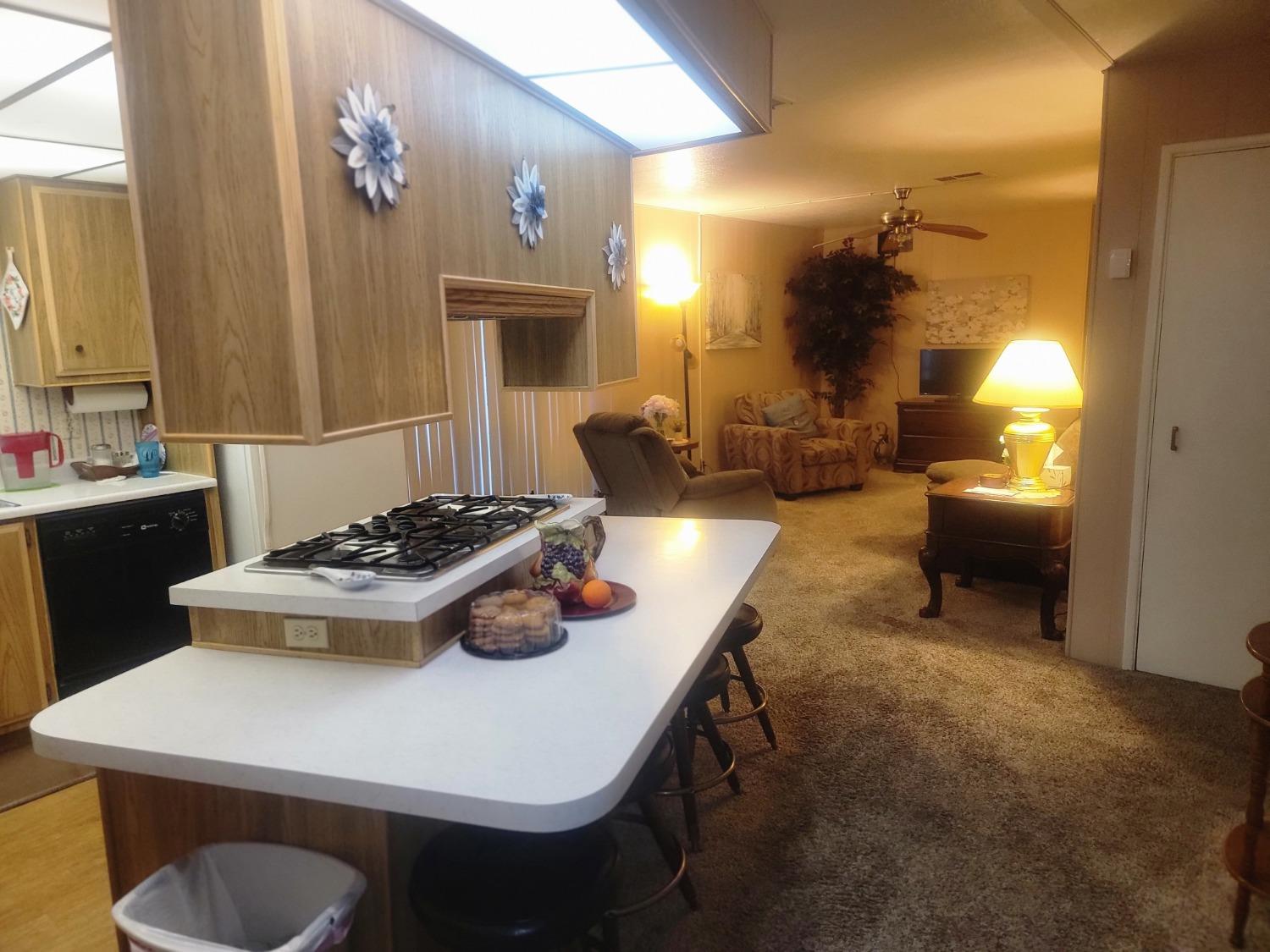1300 West Olson Avenue, Unit 52 Reedley, CA 93654 - Photo 10 of 26 a kitchen with a stove and a refrigerator