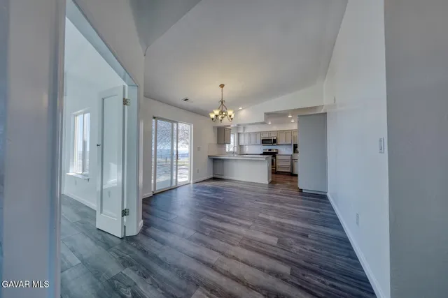 a kitchen with stainless steel appliances granite countertop white cabinets and stove