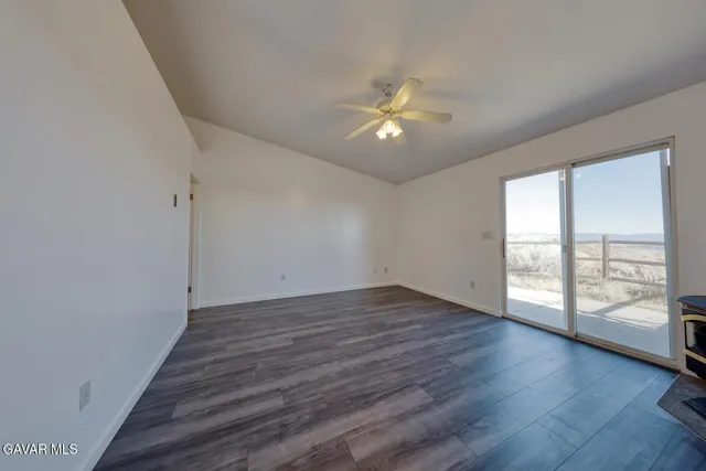 a view of a hallway with wooden floor and entryway