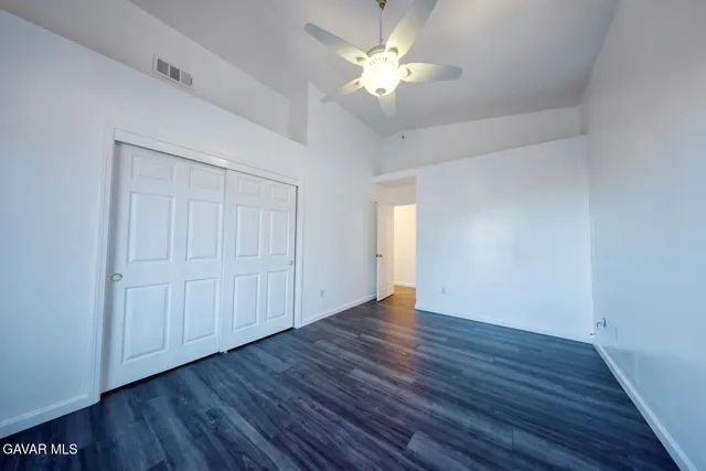 a view of a yard with wooden fence