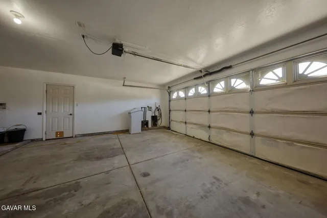 a hallway with a computer on a desk and chair