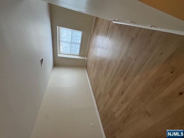 360 Knickerbocker Road, Unit 28 Dumont, NJ 07628 - Photo 4 of 11 wooden floor in an empty room with a window
