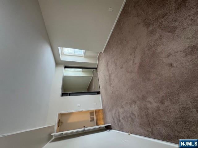360 Knickerbocker Road, Unit 28 Dumont, NJ 07628 - Photo 7 of 11 a view of an empty room with window and stairs
