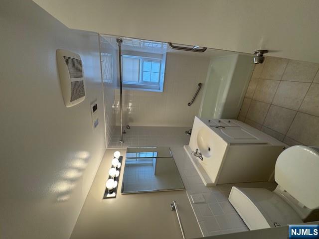 360 Knickerbocker Road, Unit 28 Dumont, NJ 07628 - Photo 8 of 11 a bathroom with a toilet sink and mirror