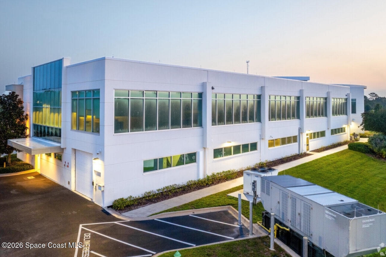 8615-8635 Holiday Springs Road Rockledge, FL 32955 - Photo 14 of 17 a view of a house with a backyard and a patio