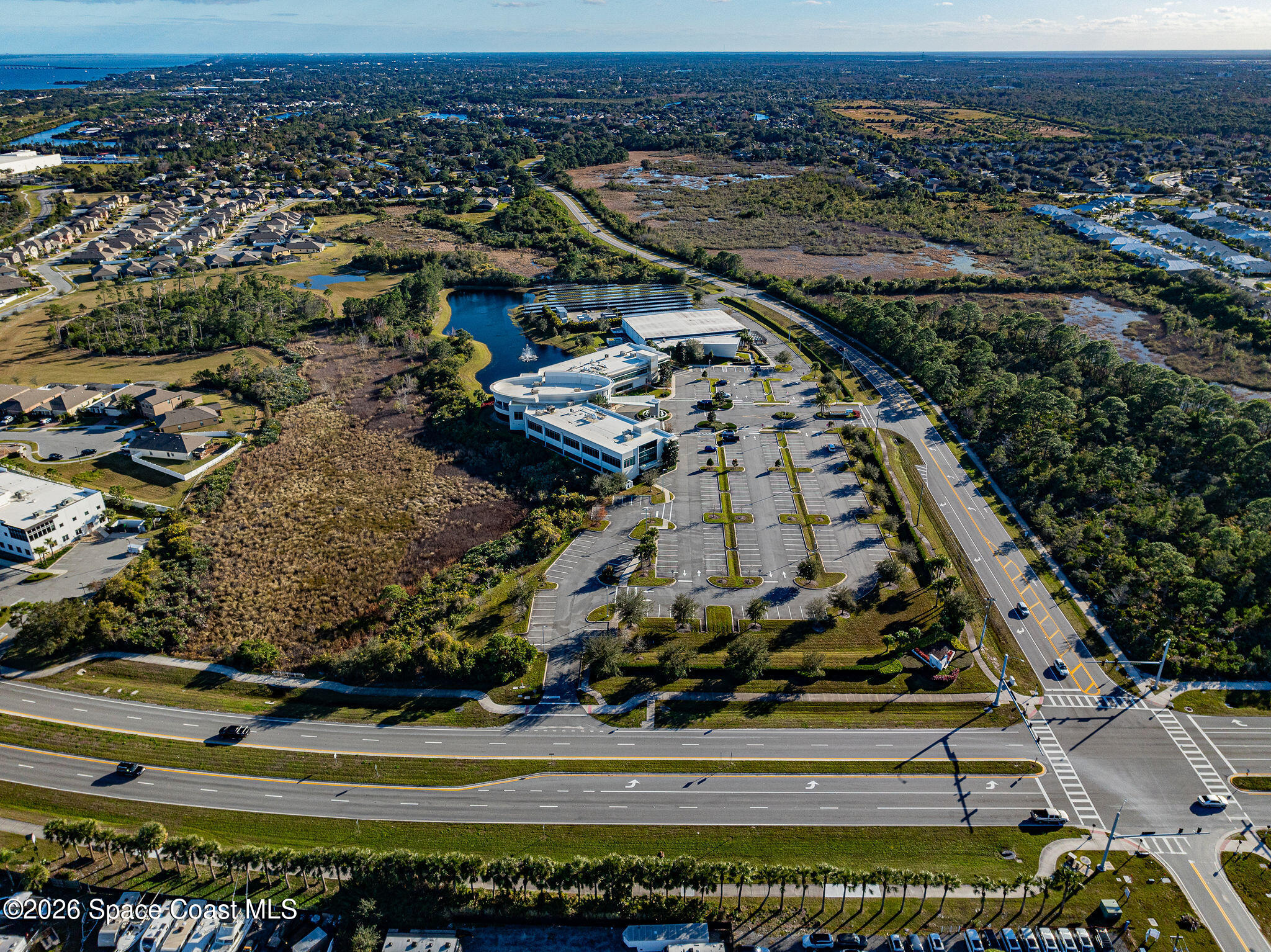 8615-8635 Holiday Springs Road Rockledge, FL 32955 - Photo 9 of 17 an aerial view of a residential building and car parked on street