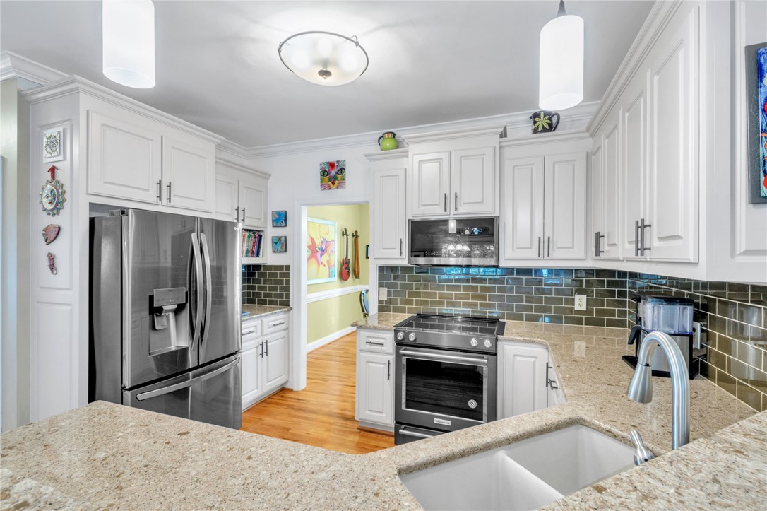 648 Mountain View Road Williamston, SC 29697 - Photo 15 of 42 Culinary delights await in this bright kitchen with granite countertops and modern appliances.
