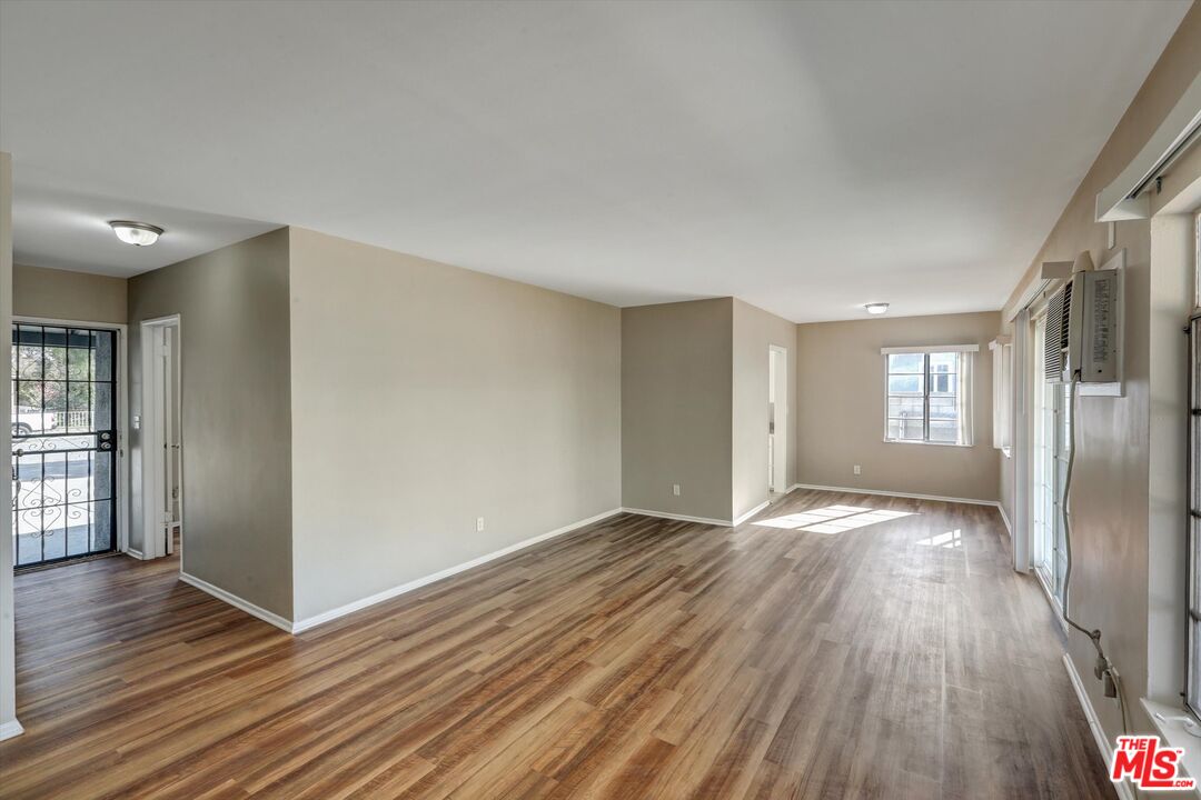 17377 Fairview Road Fontana, CA 92336 - Photo 11 of 39 a view of an empty room with wooden floor and a window