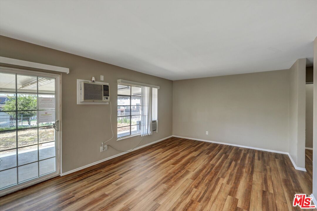17377 Fairview Road Fontana, CA 92336 - Photo 12 of 39 a view of an empty room with wooden floor and a window