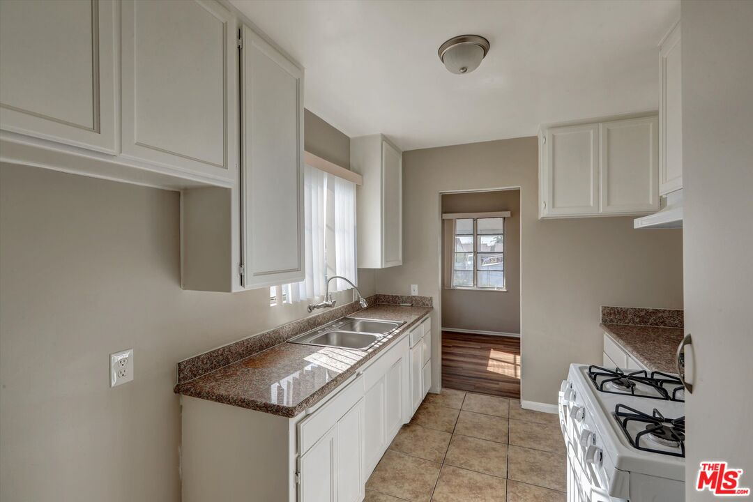 17377 Fairview Road Fontana, CA 92336 - Photo 18 of 39 a kitchen with granite countertop a sink and a stove