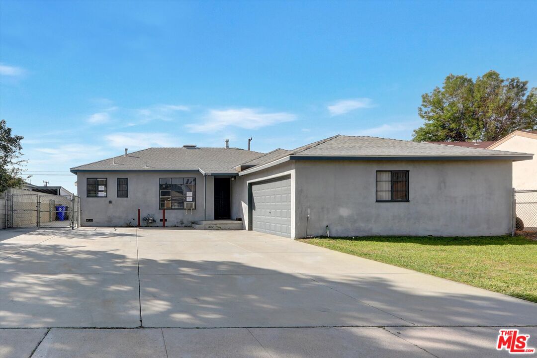 17377 Fairview Road Fontana, CA 92336 - Photo 2 of 39 a front view of a house with a yard and garage