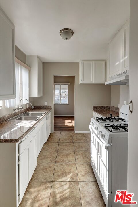 17377 Fairview Road Fontana, CA 92336 - Photo 21 of 39 a kitchen with stainless steel appliances granite countertop a stove a sink and a refrigerator