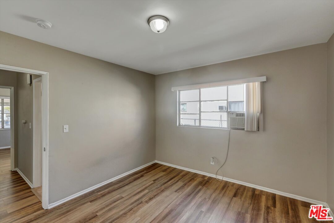 17377 Fairview Road Fontana, CA 92336 - Photo 26 of 39 an empty room with wooden floor and windows