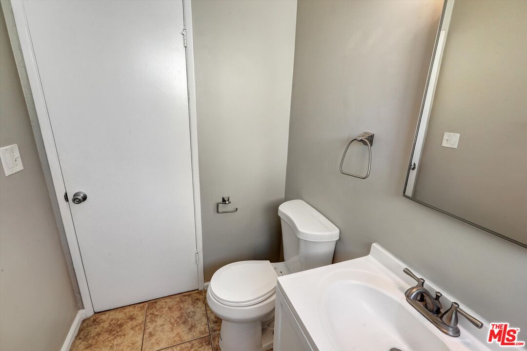 17377 Fairview Road Fontana, CA 92336 - Photo 30 of 39 a white toilet sitting next to a bathroom sink
