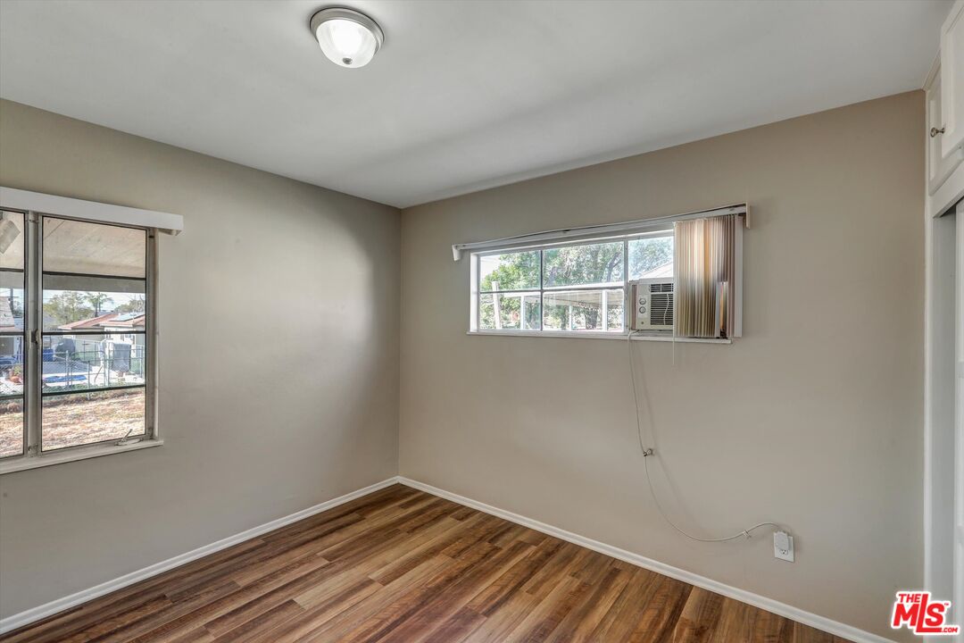 17377 Fairview Road Fontana, CA 92336 - Photo 31 of 39 a view of an empty room with wooden floor and a window