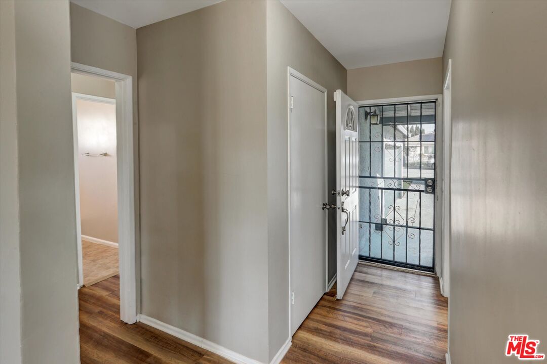 17377 Fairview Road Fontana, CA 92336 - Photo 4 of 39 a view of a hallway with wooden floor and windows