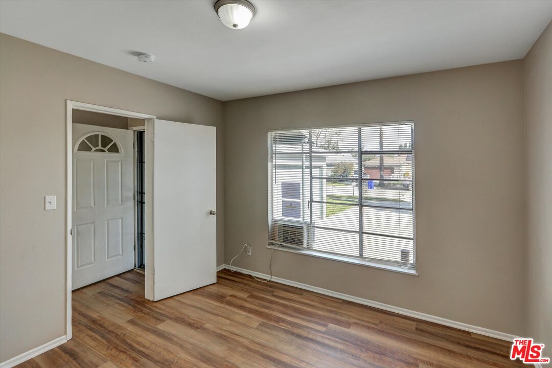 17377 Fairview Road Fontana, CA 92336 - Photo 5 of 39 an empty room with wooden floor and windows