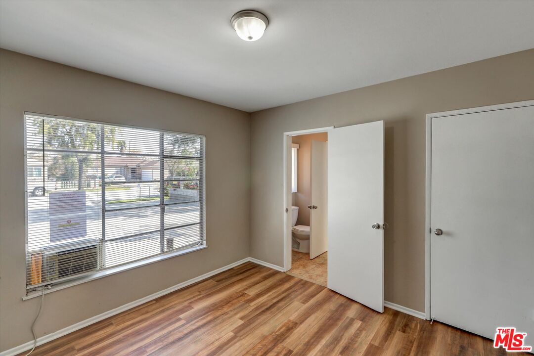 17377 Fairview Road Fontana, CA 92336 - Photo 8 of 39 a view of an empty room with wooden floor and a window
