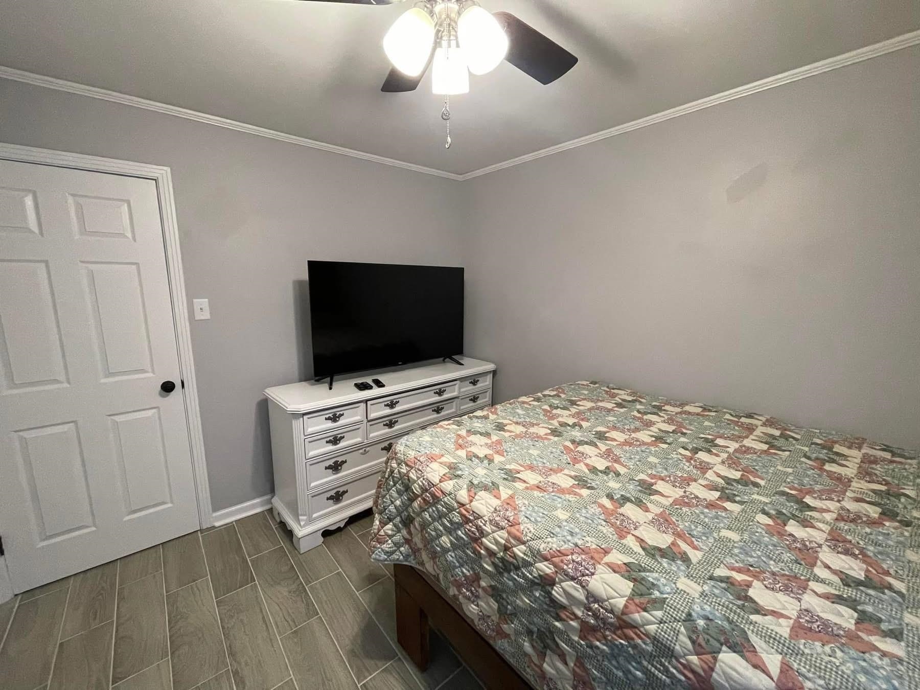 2003 Bond Ferry Road Brownsville, TN 38012 - Photo 15 of 21 Bedroom featuring wood finish floors, ornamental molding, and a ceiling fan